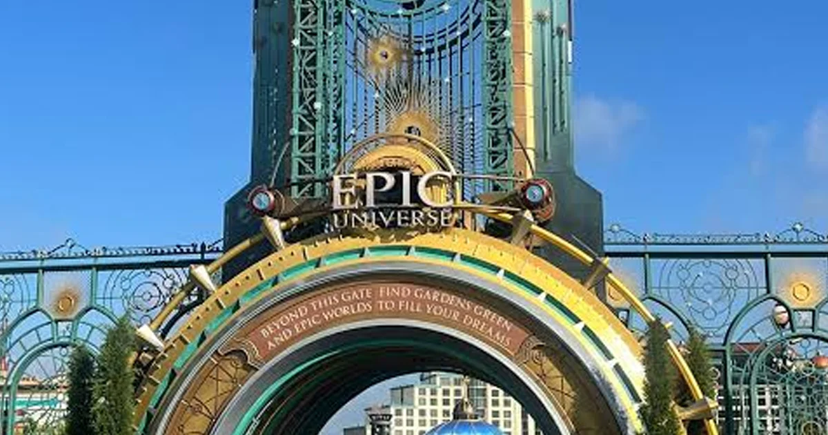 Entrance to Epic Universe that says: Beyond this gate fond gardens green, and epic worlds to fill your dreams.
